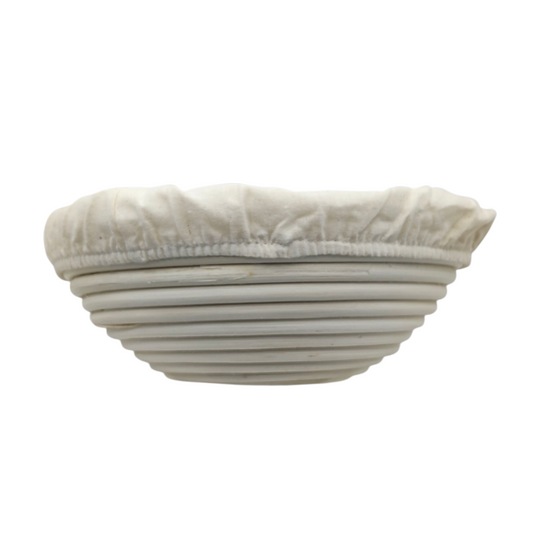 22cm round banneton with cloth liner for baking sourdough made from food-safe natural rattan on white background
