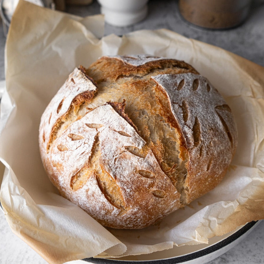 Loaf of Freshly Baked Homemade Sourdough on Ceramic Dish