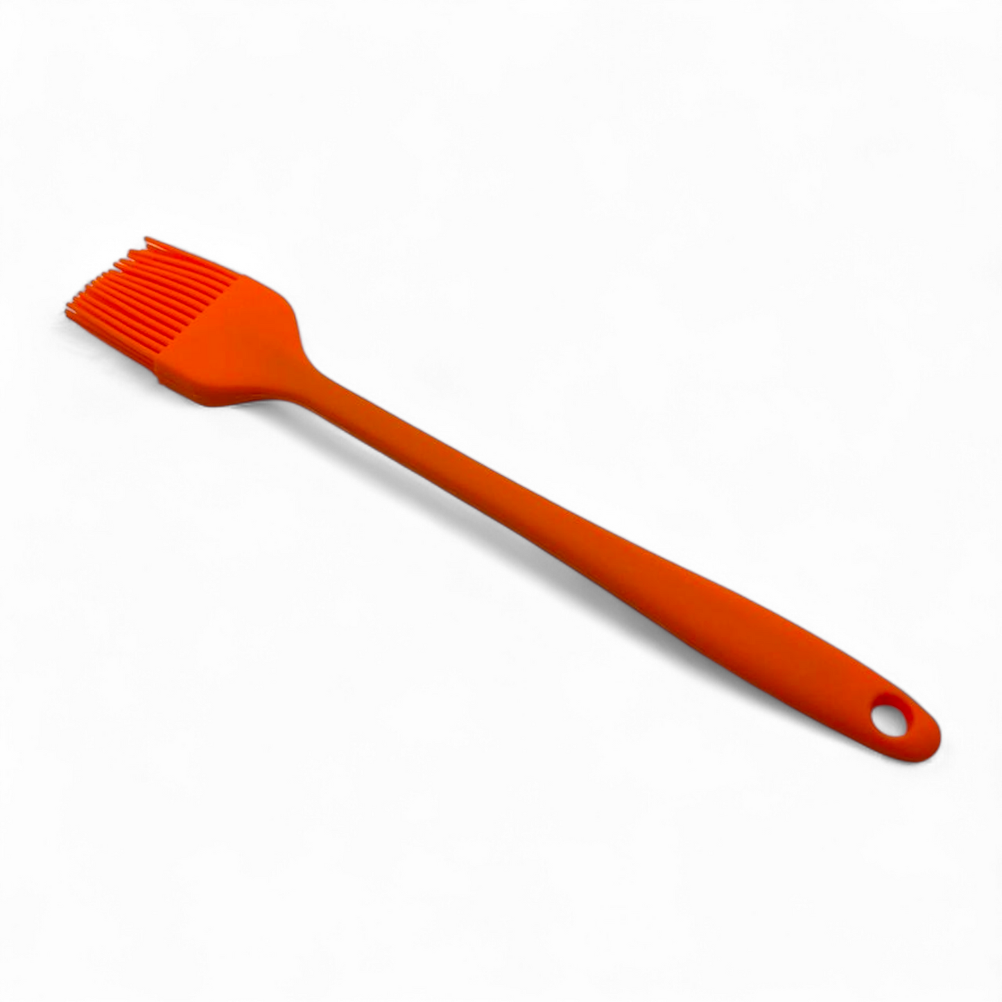 Orange pastry brush on a white background