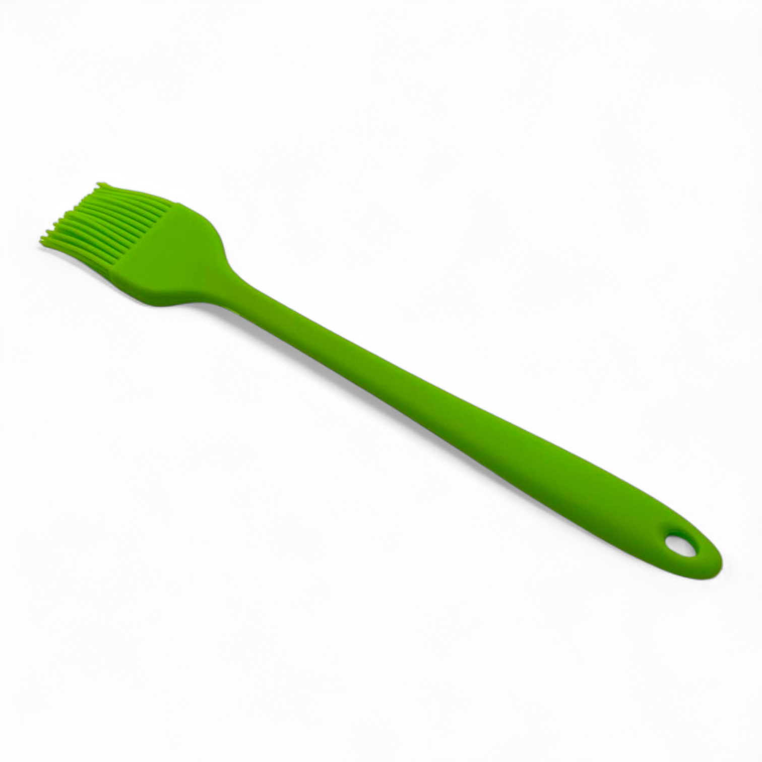 Green silicone pasty brush with a handle on a white background