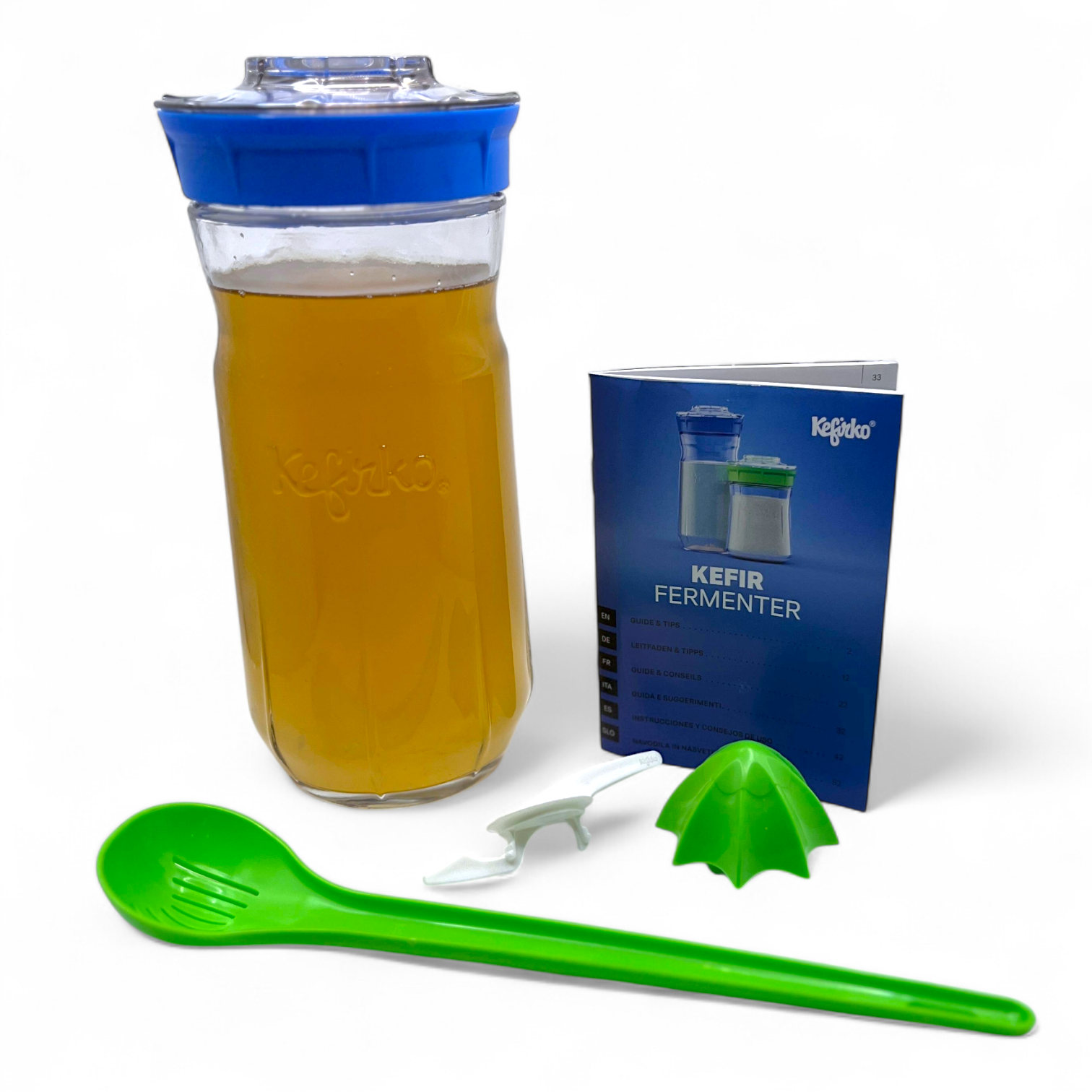 Large blue Kefirko maker kit with water kefir, spoon, and accessories on a white background