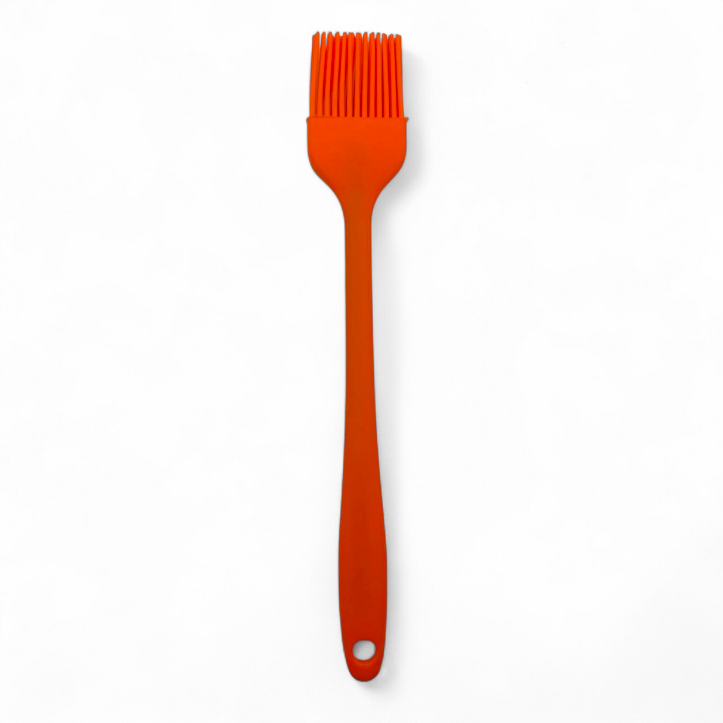 Orange silicone pastry brush on a white background upright 
