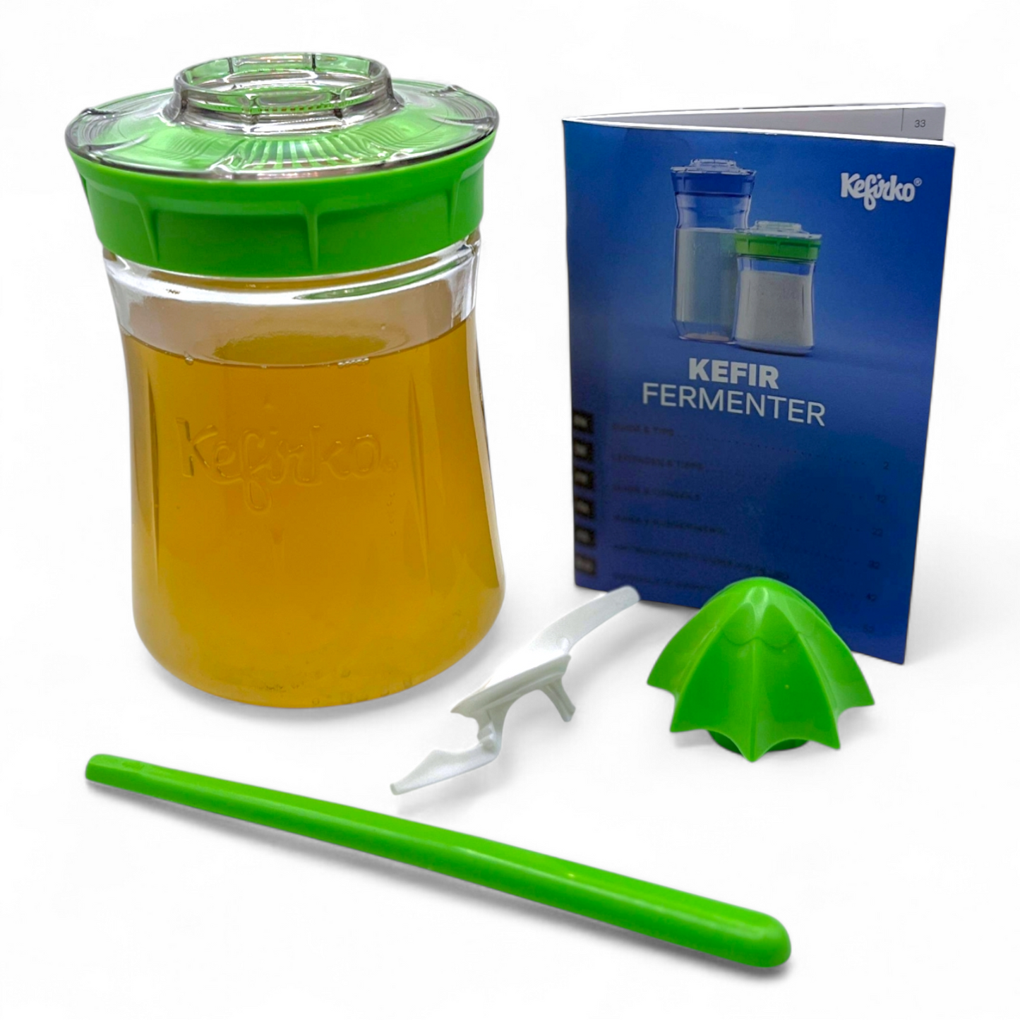 Small green Kefirko fermenter with water kefir grains, green lid and handle, accompanied by a blue Kefir guide on a white background.