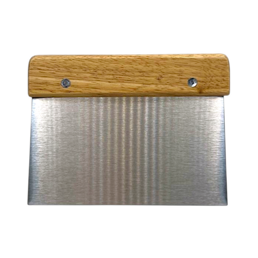 Stainless steel metal spatula with wooden handle on a white background upright 